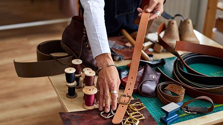 Craftsman working on a handmade leather belt