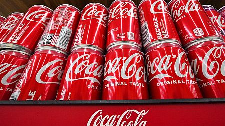 Cans of Coca-Cola are on display at a supermarket in April 2022.